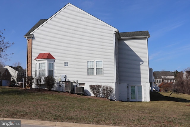 210 Potomac Ridge Dr, Fort Washington, MD 20744 - back of house with central air condition unit, a lawn, and roof with shingles