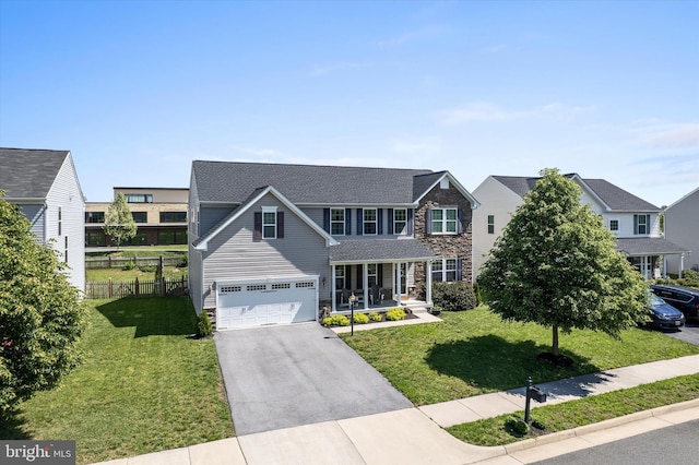view of front of property featuring stone siding, covered porch, driveway, and an attached garage