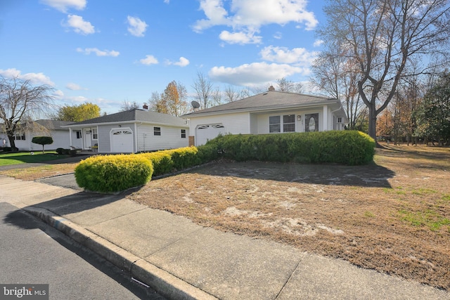 view of front of house featuring concrete driveway and an attached garage