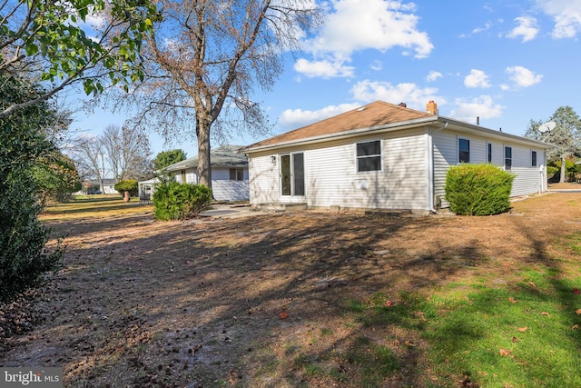 rear view of property with a patio area and a chimney