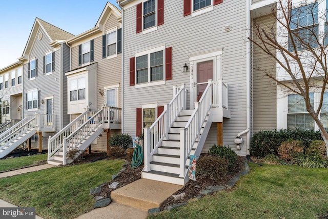 view of property featuring a residential view and a front lawn