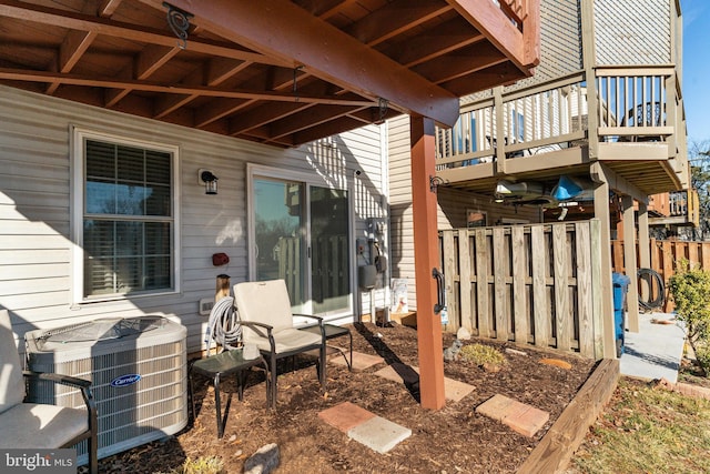 view of patio / terrace featuring central air condition unit and fence