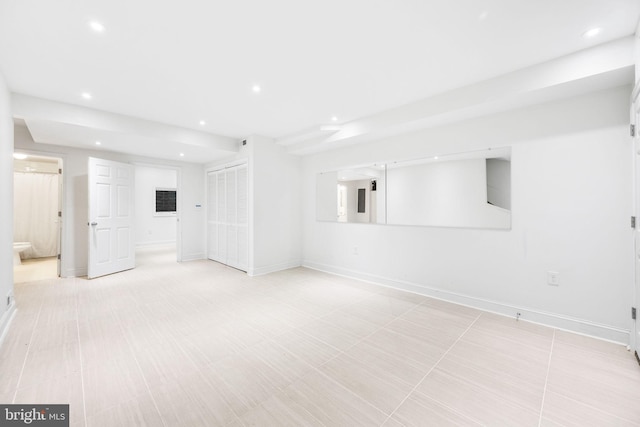 unfurnished room with recessed lighting and baseboards