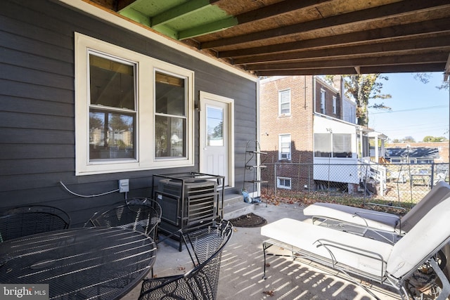 wooden terrace with a patio area and fence