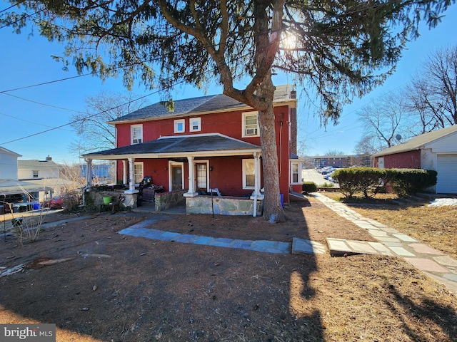 view of front facade with a chimney and a porch