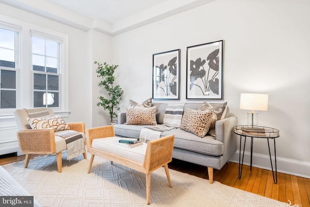 living area with baseboards and hardwood / wood-style floors