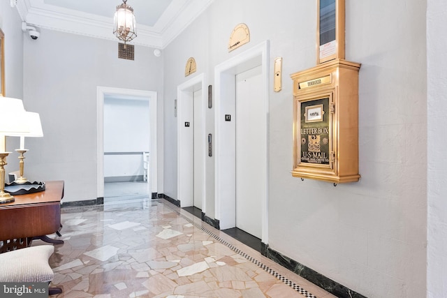 interior space featuring marble finish floor, crown molding, elevator, a chandelier, and baseboards