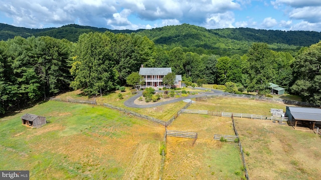 bird's eye view with a mountain view, a view of trees, and a rural view