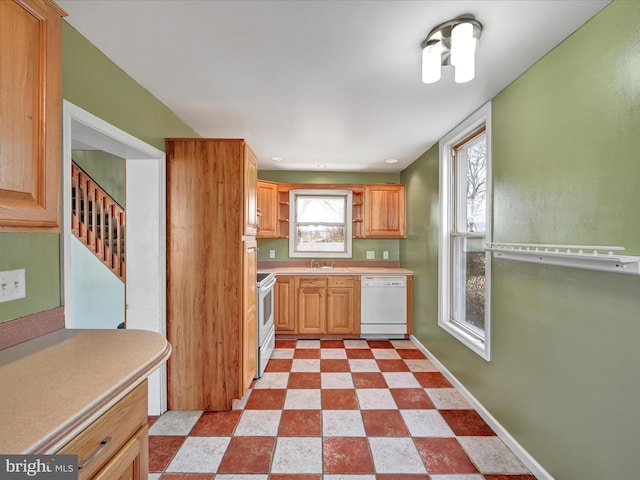 kitchen featuring electric range oven, open shelves, baseboards, dishwasher, and light floors