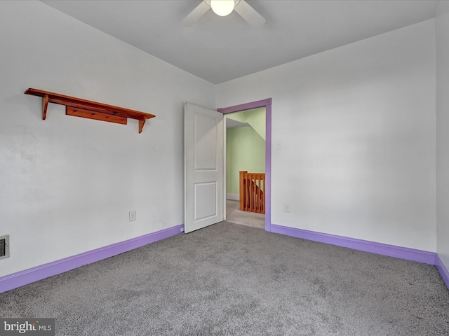 empty room featuring carpet flooring, ceiling fan, and baseboards