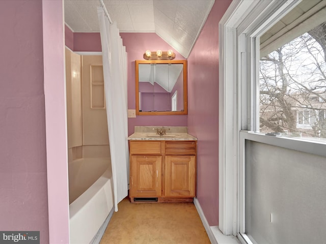 full bathroom featuring lofted ceiling, shower / bath combo with shower curtain, vanity, and a wealth of natural light