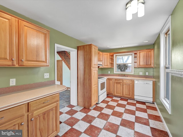 kitchen with white appliances, light countertops, light floors, open shelves, and a sink