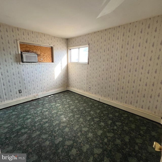 spare room with carpet floors and wallpapered walls