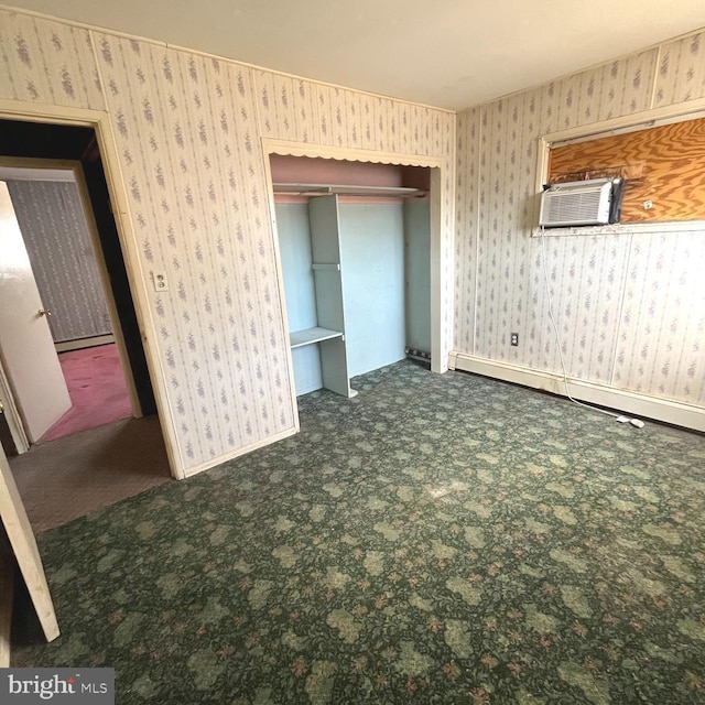 unfurnished bedroom featuring wallpapered walls, carpet, and a closet