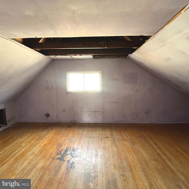 bonus room featuring lofted ceiling and hardwood / wood-style flooring