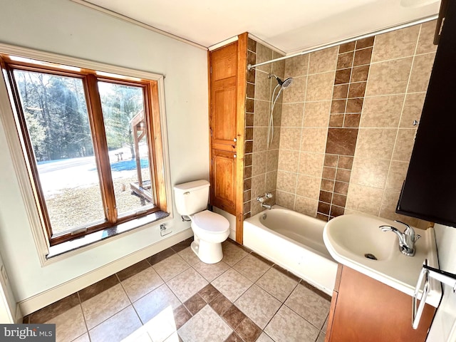 bathroom with baseboards, a sink, toilet, and tile patterned floors