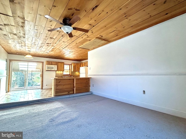 interior space featuring wood ceiling, baseboards, and freestanding refrigerator