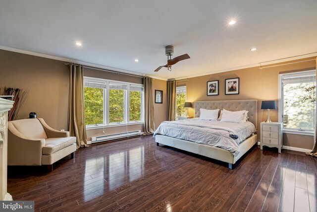 bedroom with crown molding, multiple windows, a baseboard heating unit, and wood finished floors