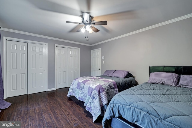 bedroom with multiple closets, ornamental molding, ceiling fan, and wood finished floors