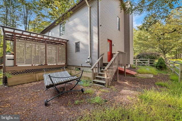 exterior space with fence and a wooden deck