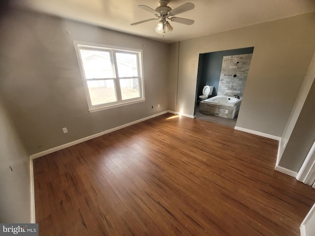 unfurnished bedroom with baseboards and wood finished floors