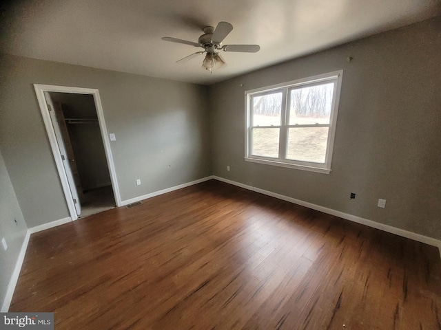 interior space featuring dark wood-style flooring, visible vents, and baseboards