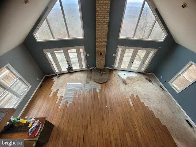 interior space with french doors, plenty of natural light, and wood finished floors