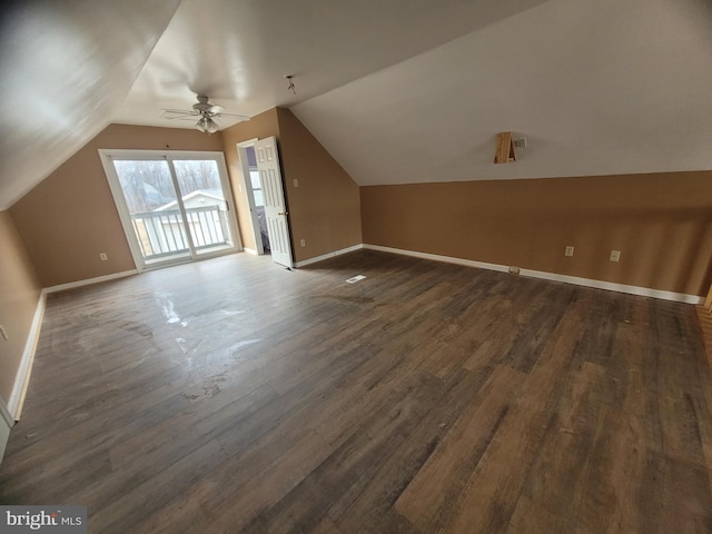 additional living space featuring lofted ceiling, ceiling fan, baseboards, and dark wood-style flooring