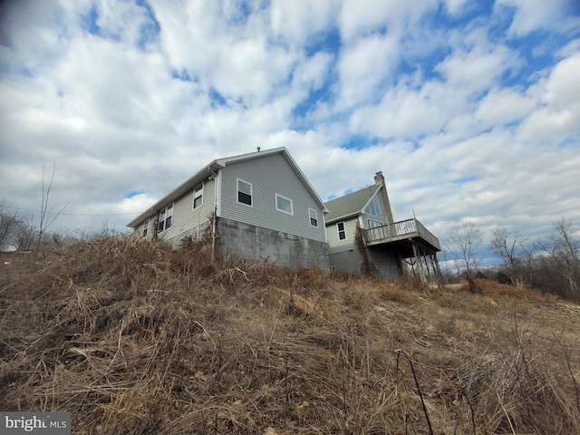 view of side of home with a deck