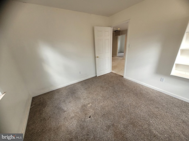 unfurnished bedroom with carpet floors and baseboards