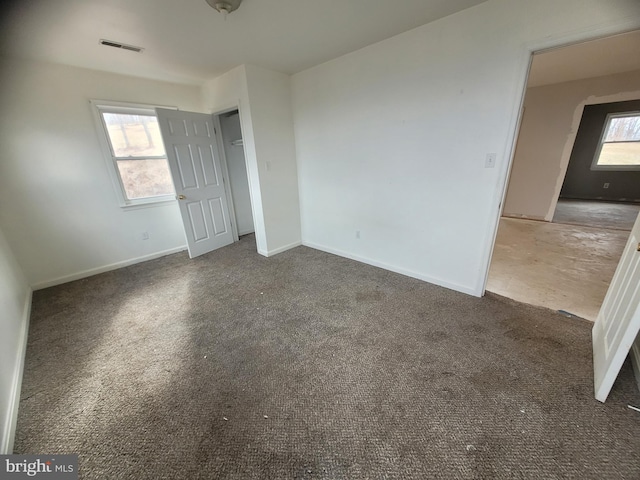 unfurnished bedroom with baseboards, visible vents, and carpet flooring