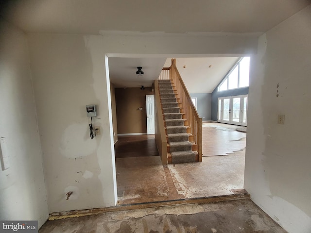 stairway with lofted ceiling and french doors