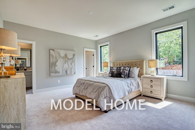 bedroom featuring baseboards, multiple windows, visible vents, and carpet flooring