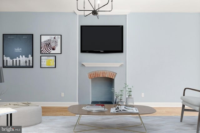 living room with a notable chandelier, baseboards, and wood finished floors