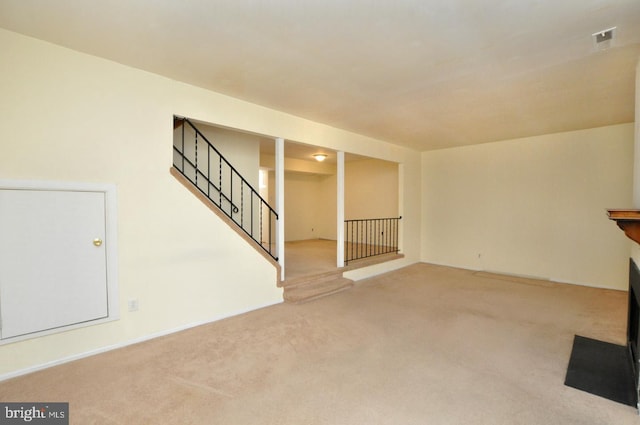 unfurnished living room with stairs, carpet floors, and visible vents