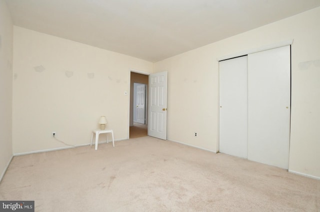 unfurnished bedroom featuring a closet and carpet flooring