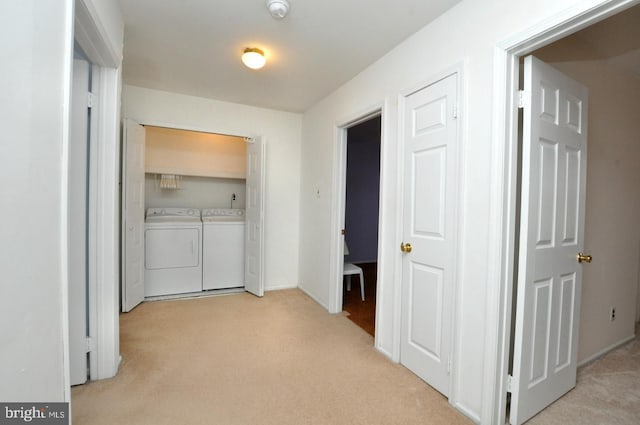 washroom with light carpet, laundry area, and washer and dryer