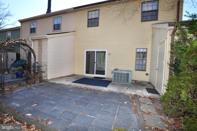 rear view of property featuring a patio area and central AC unit