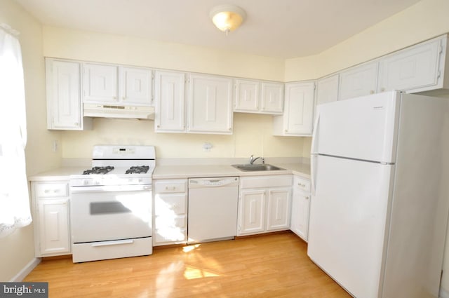 kitchen featuring light wood-style flooring, under cabinet range hood, white appliances, a sink, and white cabinets