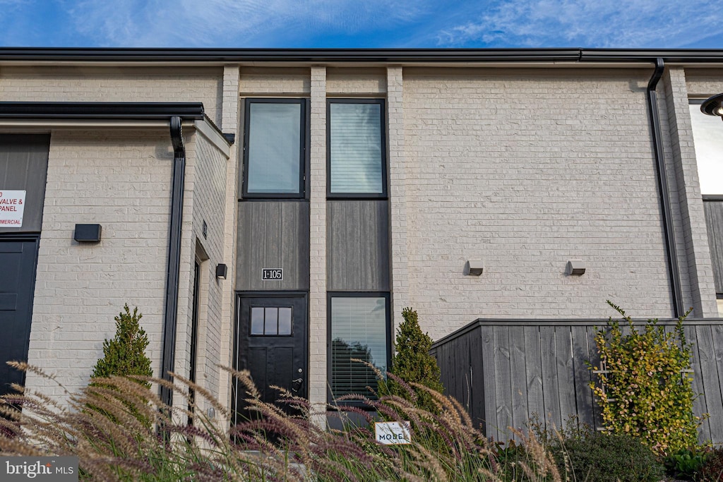 exterior space featuring brick siding