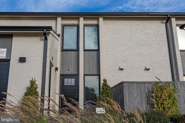 exterior space featuring brick siding