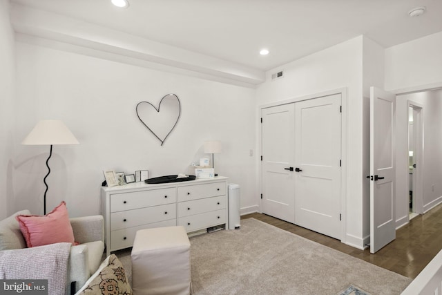 living area featuring recessed lighting, visible vents, and wood finished floors