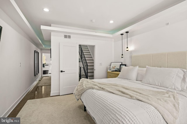 bedroom with visible vents, wood finished floors, recessed lighting, baseboards, and a spacious closet