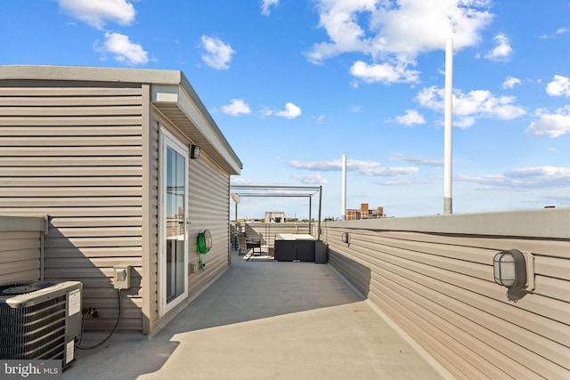 view of patio / terrace featuring central AC unit and a balcony