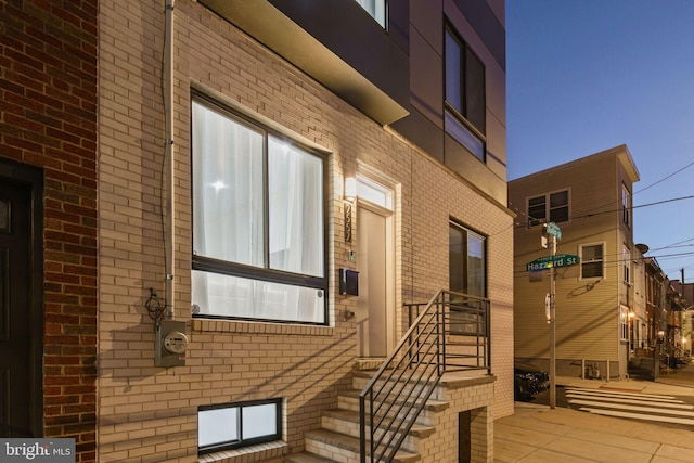 property entrance featuring brick siding