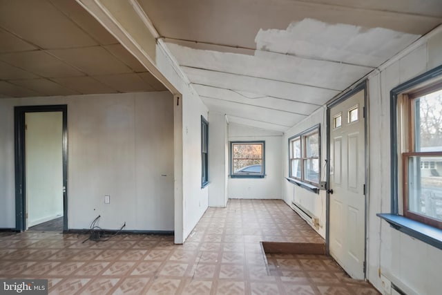 interior space featuring a baseboard radiator, plenty of natural light, lofted ceiling, and baseboard heating