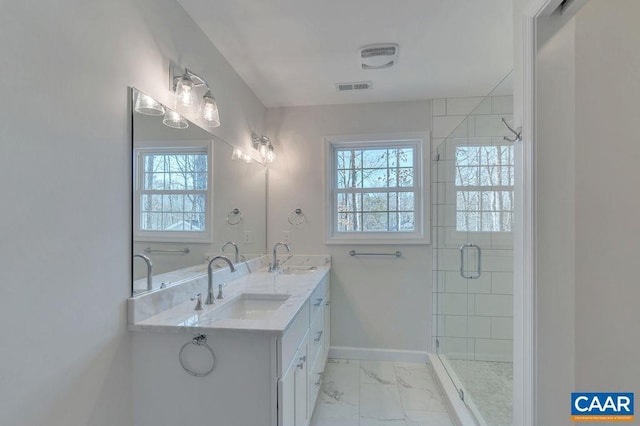 full bath with marble finish floor, a sink, and a wealth of natural light