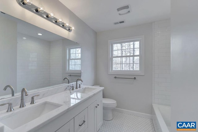 full bathroom with toilet, a sink, visible vents, and baseboards