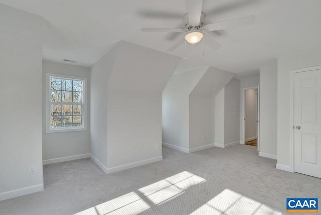 bonus room featuring light carpet and baseboards