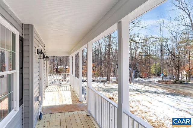 snow covered deck with covered porch